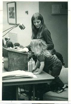 woman standing a podium next to child